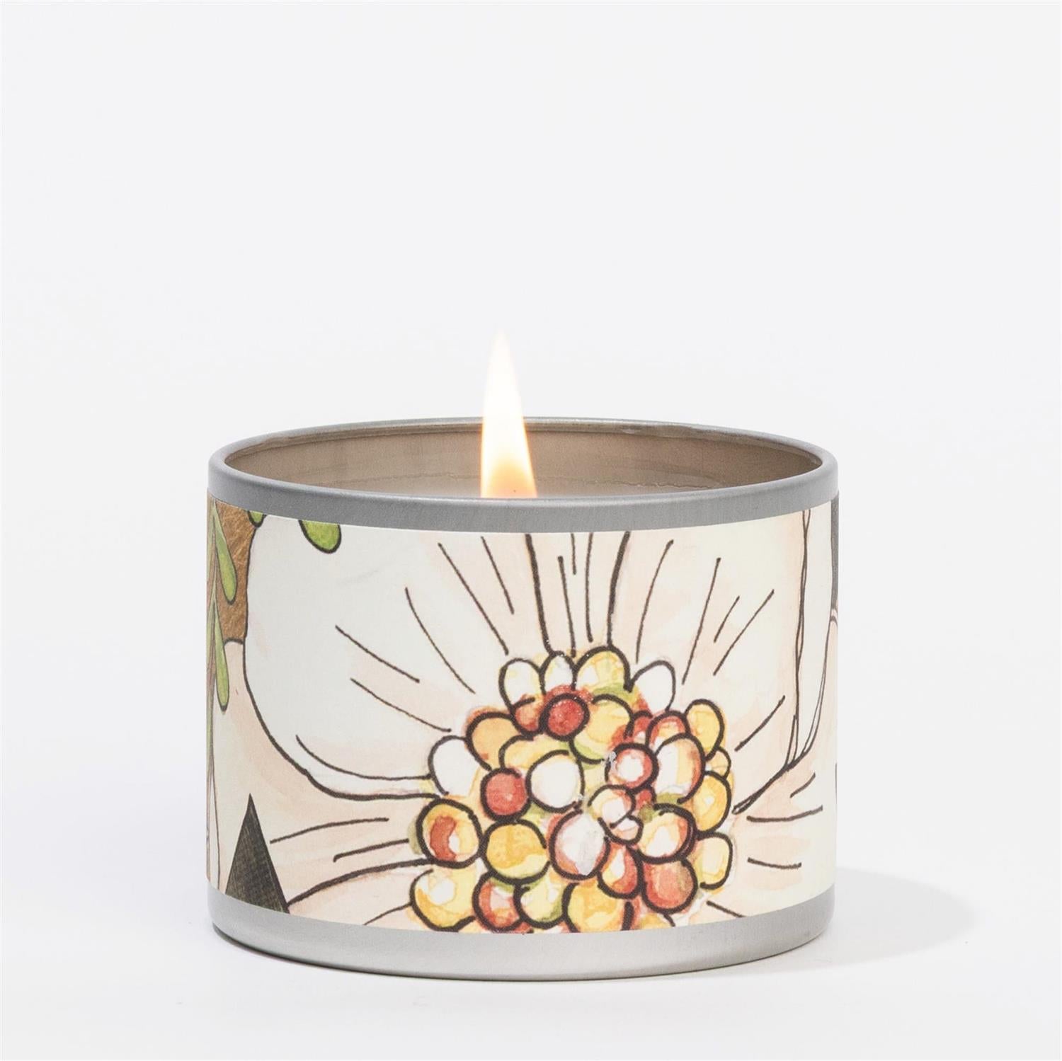 Candle in a decorative container with a floral design on a white background