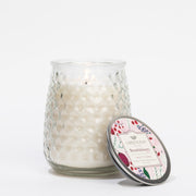 Glass candle with decorative lid on a white background