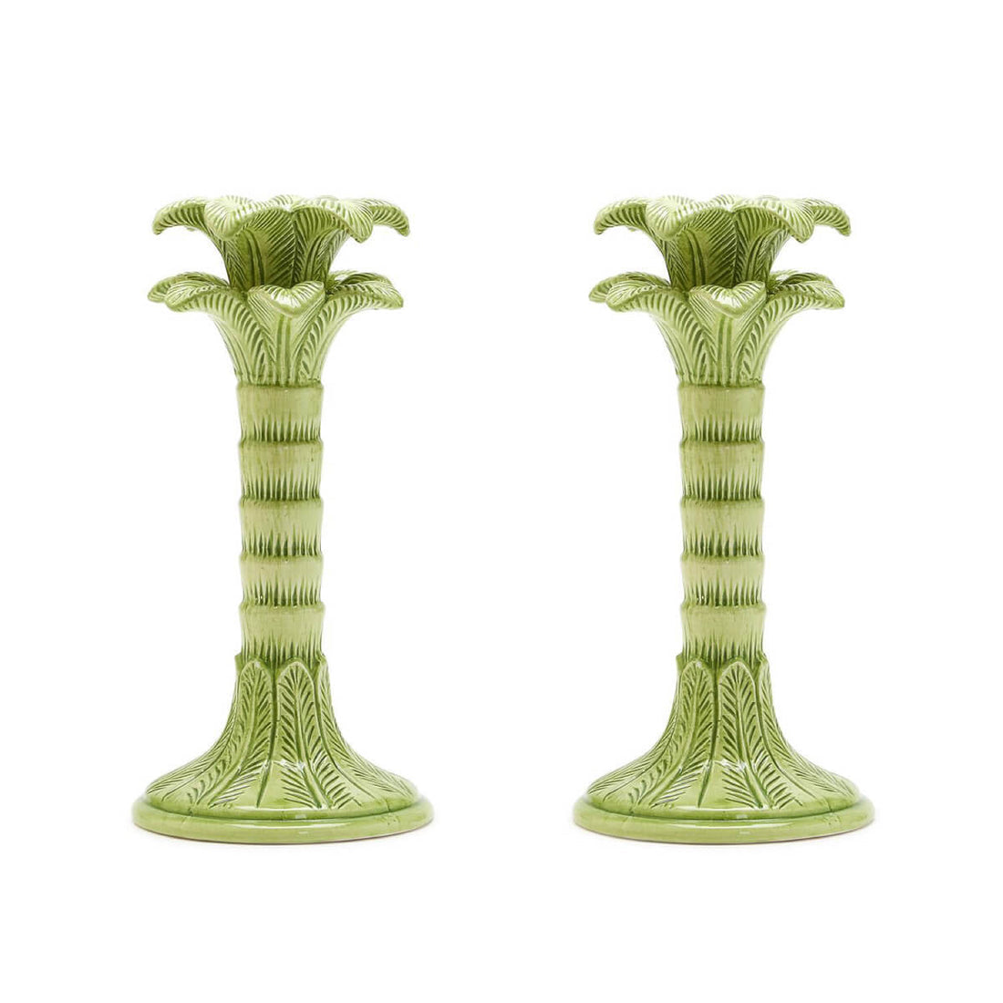 Two green palm tree candlestick holders on a white background.
