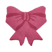 Pink bow-shaped pillow on a white background