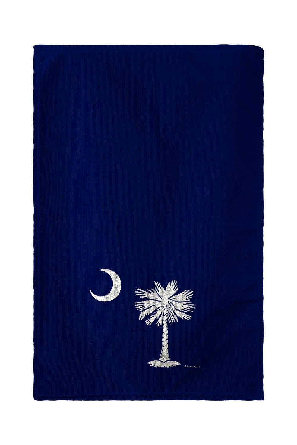 Navy blue towel with white palm tree and moon design on a white background
