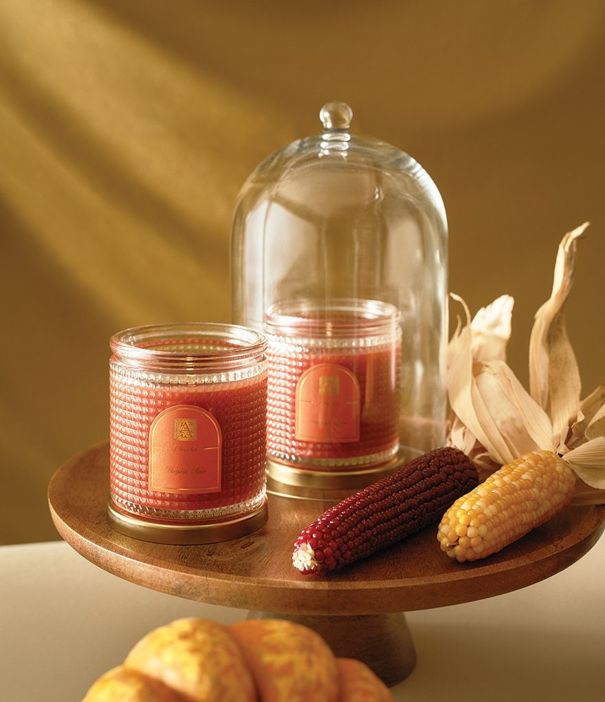 Seasonal - Candle - Pumpkin Spice - 6oz. Sitting on a stand with a glass dome 