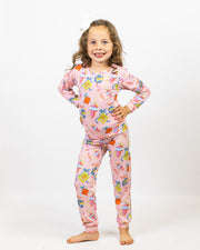 child wearing pink pajamas with tiger faces and ornaments on a white background