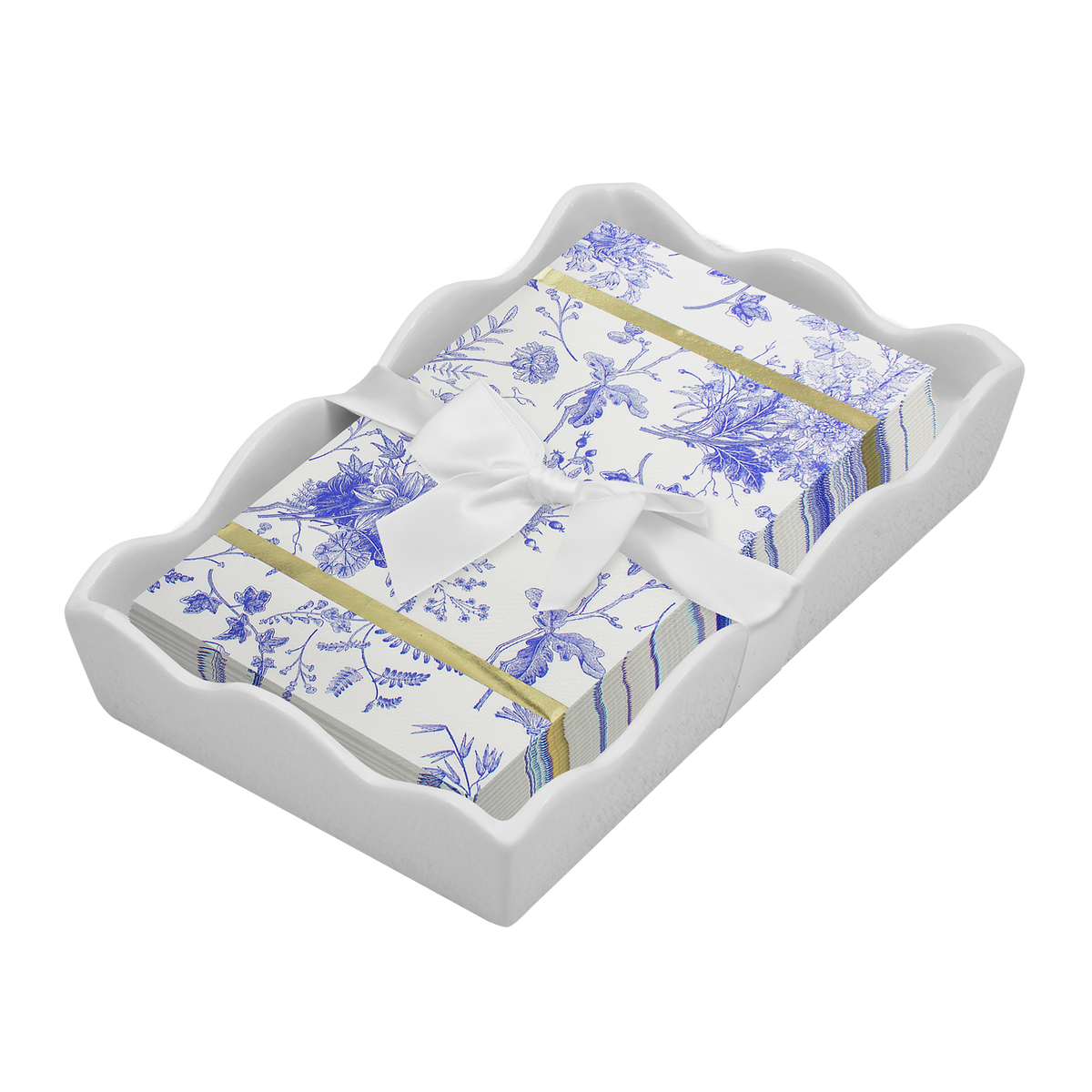 blue floral pattern guest paper napkins and white bow in wavy ceramic napkin holder on a white background 
