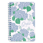 Notebook with blue floral design and 'Amazing Grace' text on a white background