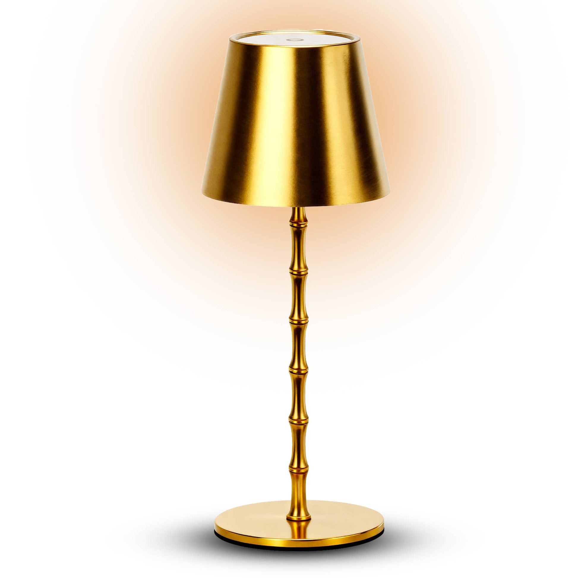 Gold table lamp with a bamboo-style base on a white background