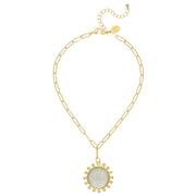 Gold necklace with a pendant on a white background, featuring the brand 'Susan Shaw'.