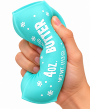 turquoise plastic stic of butter that says 4oz butter with snowflake graphics being squeezed by a hand on a white background