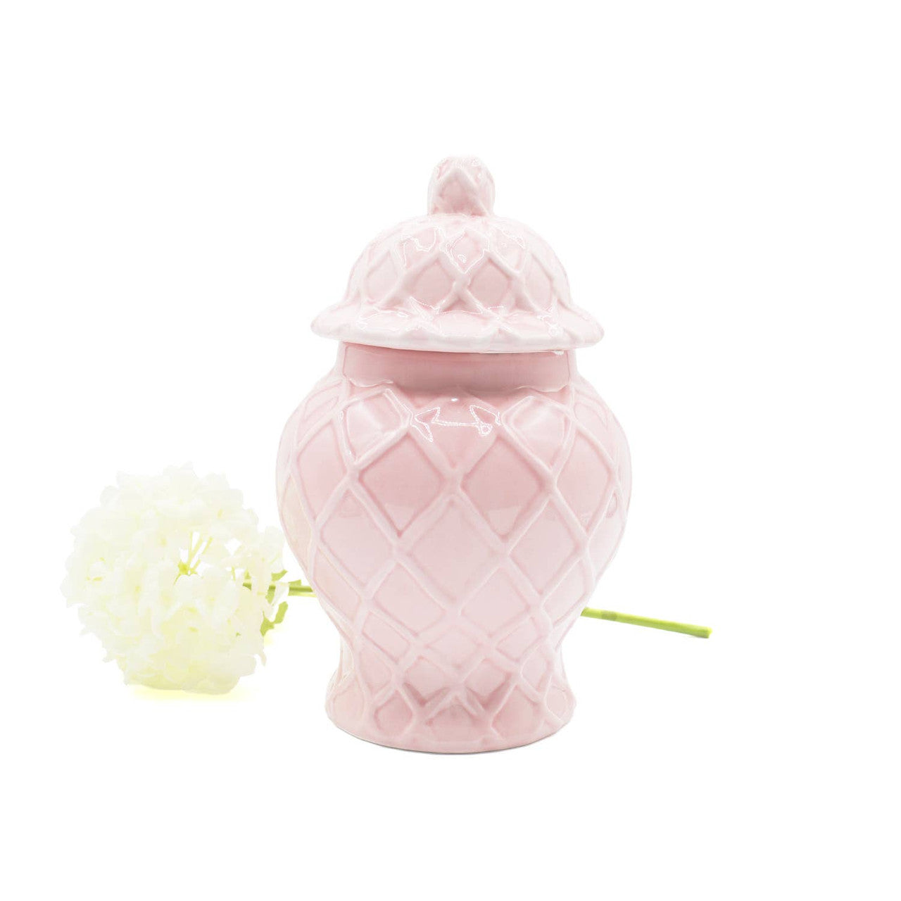 Pink decorative vase with a textured design on a white background