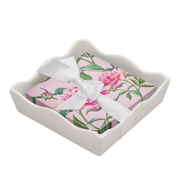 Pink Peony cocktail napkins with a white ribbon inside a decorative white container on a white background