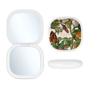 Toss designs Brand Milan compact mirror case shown open with two mirrors, alongside the closed lid featuring a vintage botanical and butterfly illustration, and the translucent white cap resting below on a clean white background.