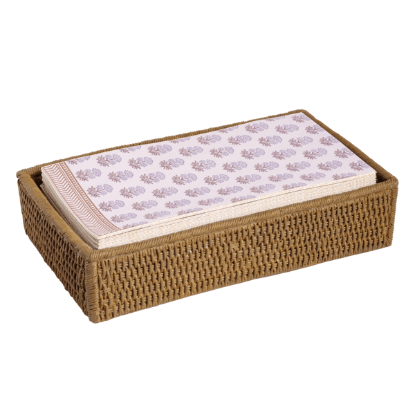 wicker napkin holder with guest towells inside on  a white background