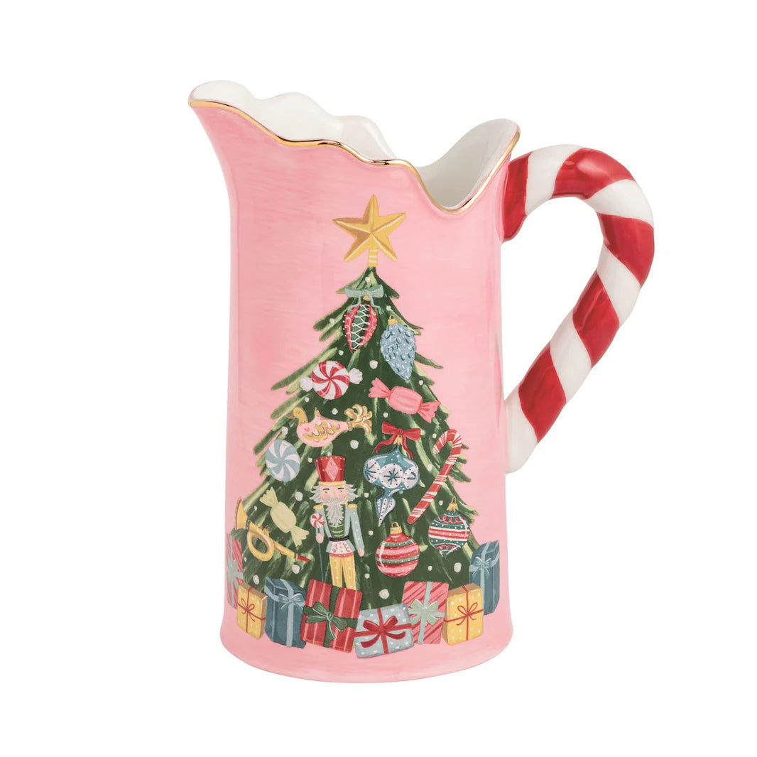 Pink pitcher with a Christmas tree design and candy cane handle on a white background