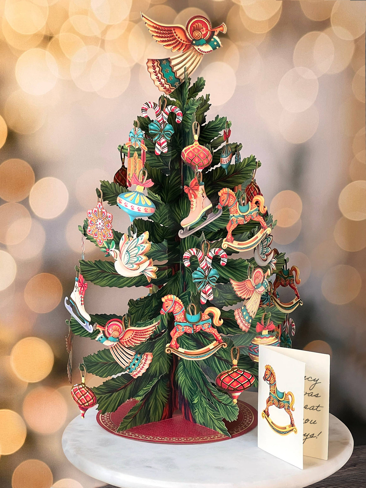 Decorative Christmas tree with colorful ornaments on a blurred light background