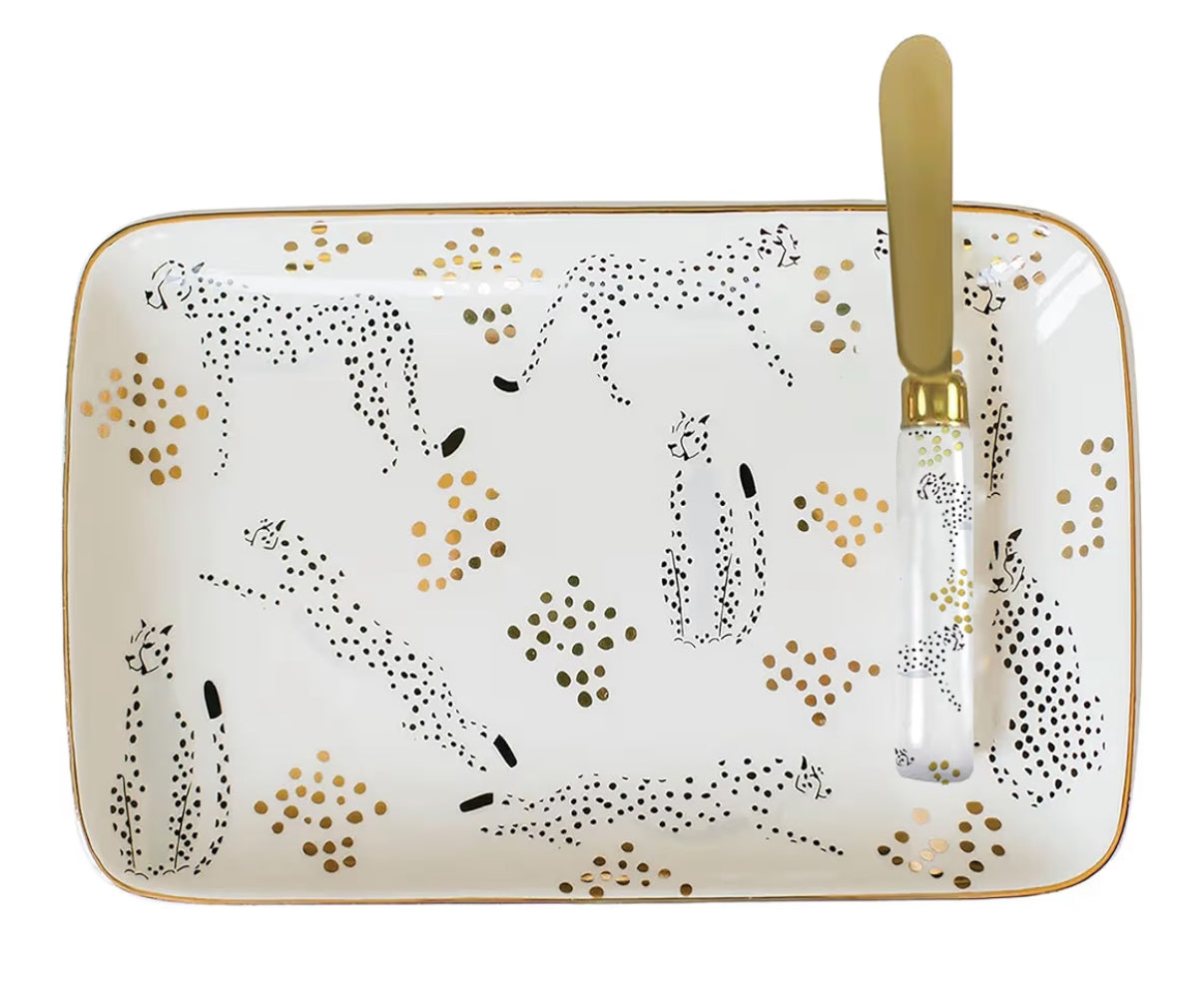 Rectangular ceramic tray with cheetah design and gold knife on a white background