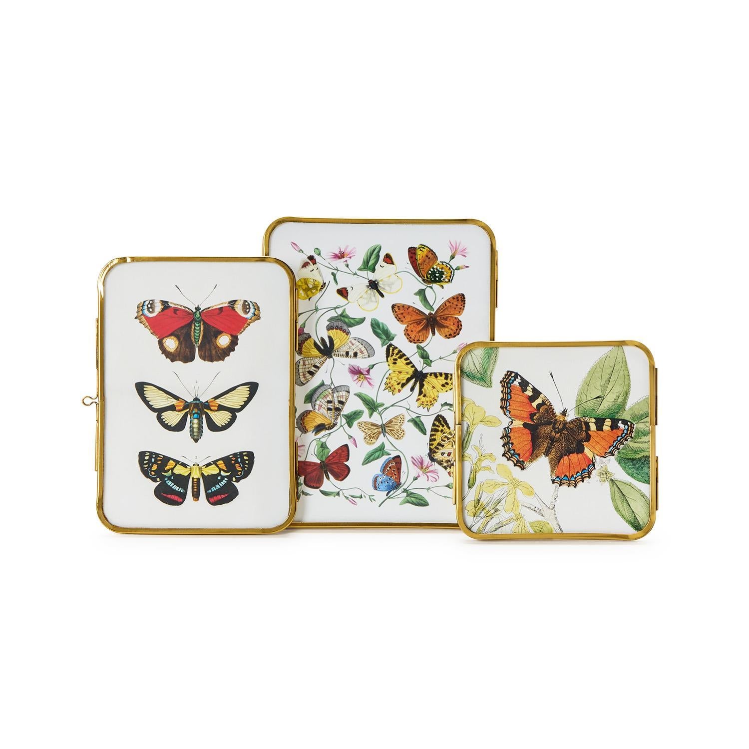 Set of three decorative trays with butterfly designs on a white background