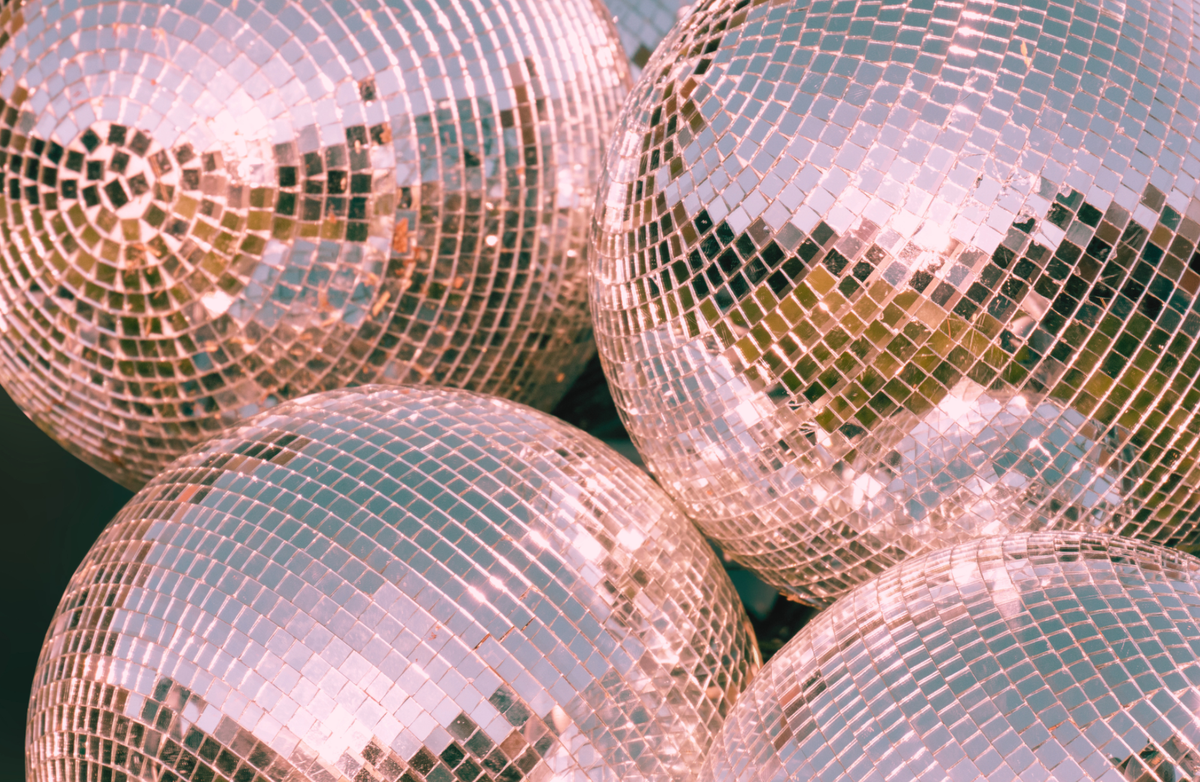 Close-up of reflective disco balls with a greenish tint