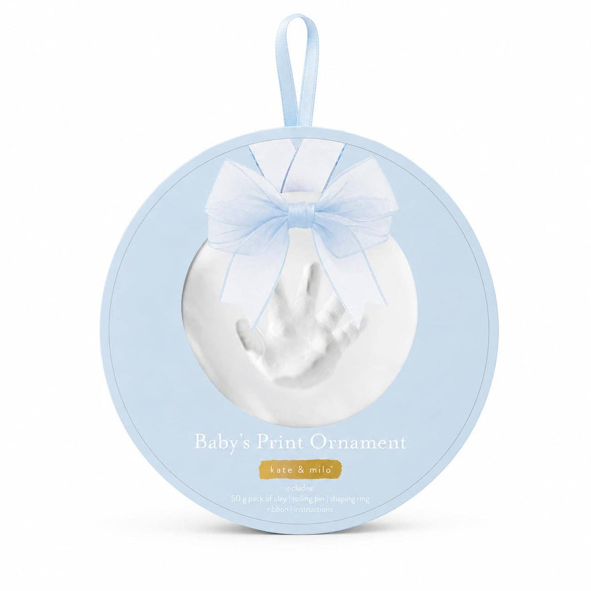 A round baby keepsake ornament package with a hanging loop, featuring a white baby print molded into the center and tied with a pale blue ribbon bow. The front reads 'Baby's Print Ornament' on a clean white background.