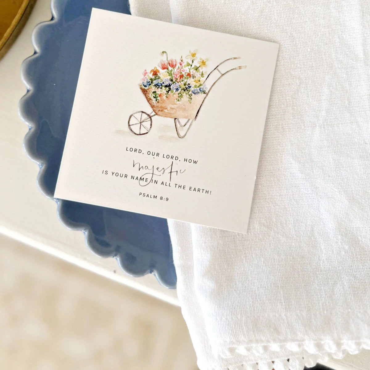 Card with floral design and biblical text on a white surface