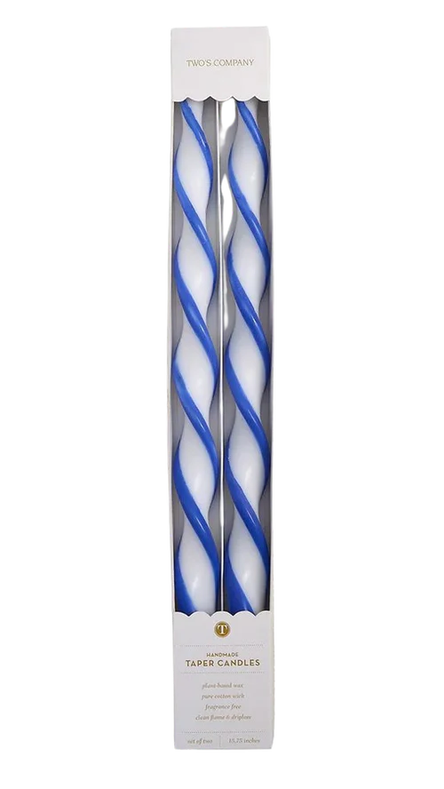 Two blue and white twisted candles in a packaging box on a white background