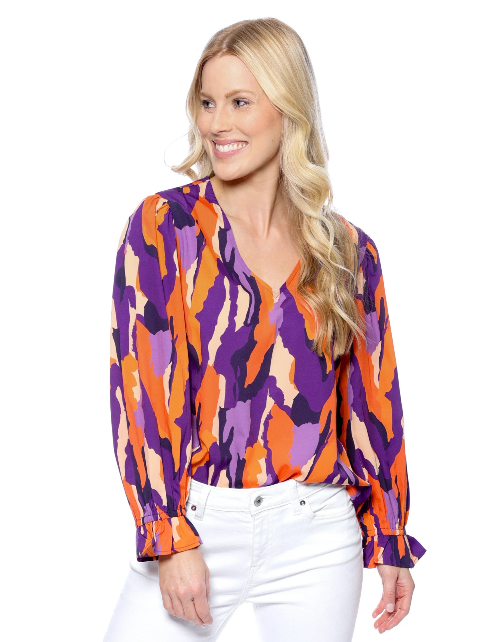 Woman wearing a colorful patterned blouse on a white background