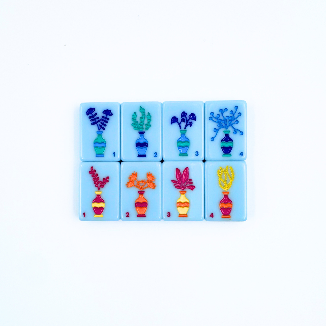 Set of colorful Mahjong tiles with floral designs on a white background