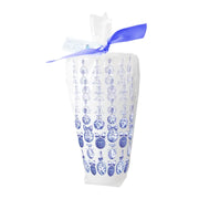 White cups with blue floral pattern and a blue ribbon on a white background