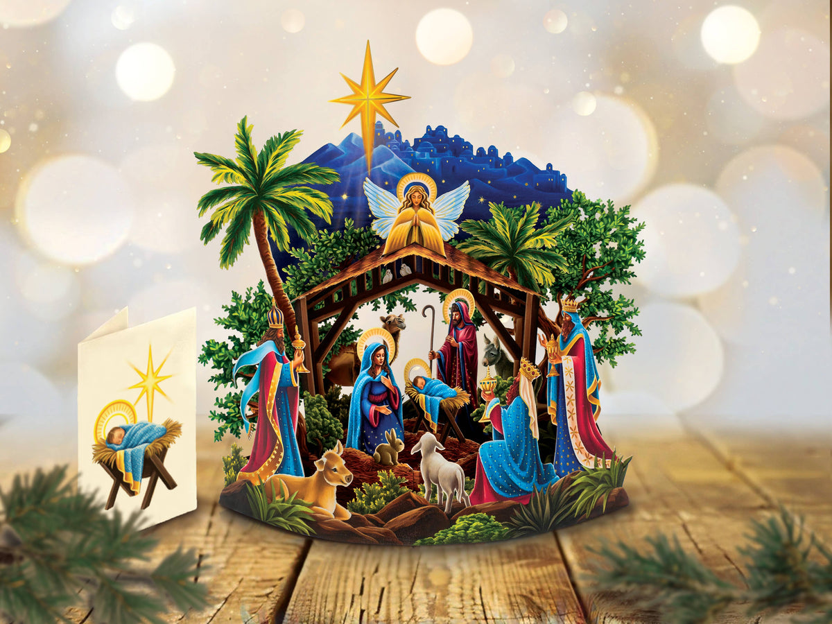Freshcut Paper pop-up card Nativity scene with characters and animals on a wooden platform with a blurred light background
