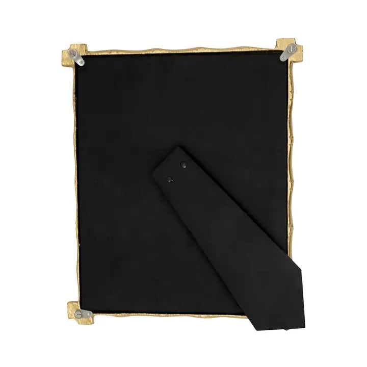 Black fabric picture frame back with a gold border and clips on a white background