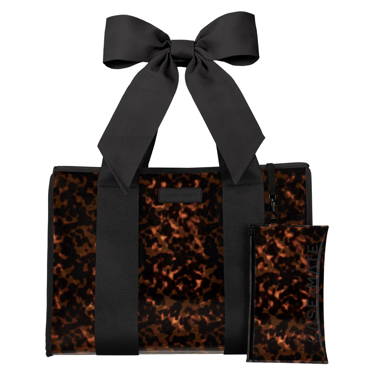 A structured tote bag with a glossy tortoiseshell pattern in brown and black, featuring a large matching black satin bow on the handle and a small matching zip pouch placed in front, shown on a plain white background.