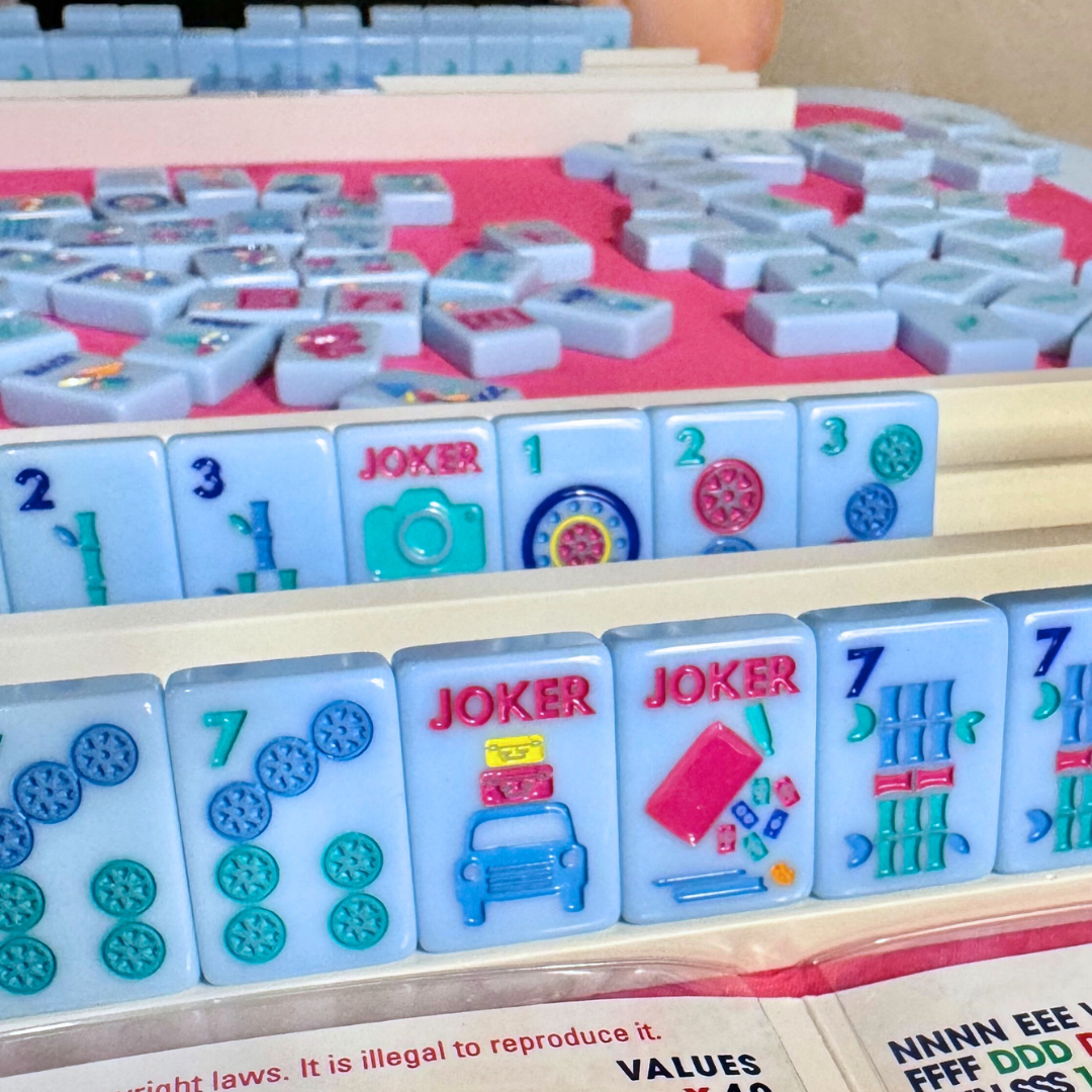 Close-up of colorful Mahjong tiles with jokers on a table