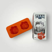 Orange ice mold with paw prints next to a 'Team Ice' branded box on a white background