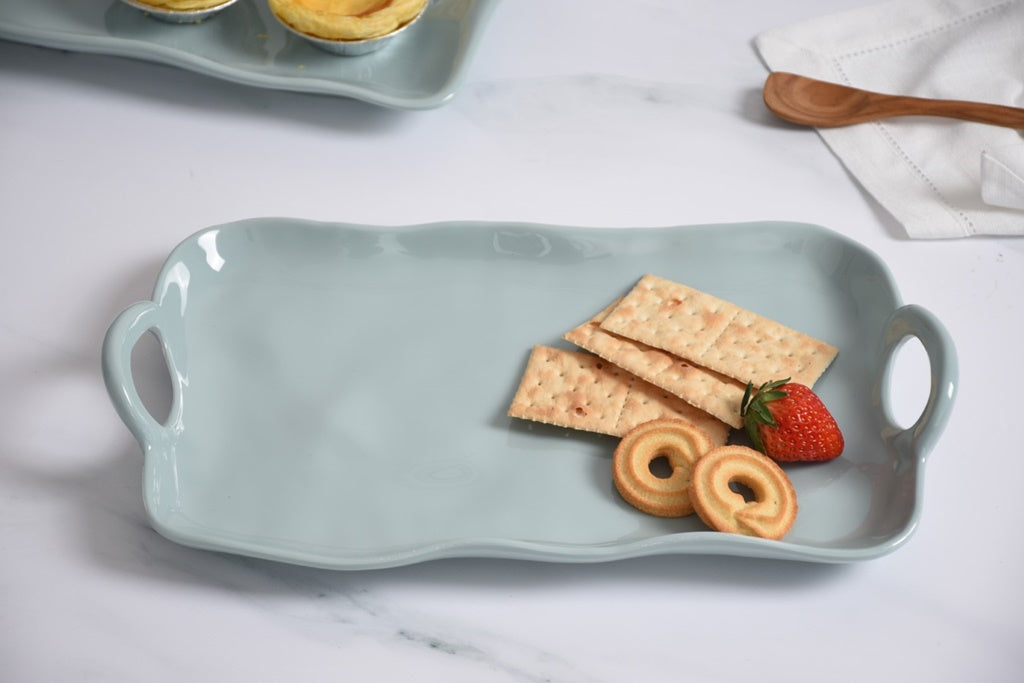 Pampa Bat Light blue melamine tray with crackers, cookies, and a strawberry on a white surface.