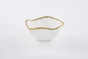 White bowl with gold rim on a white background