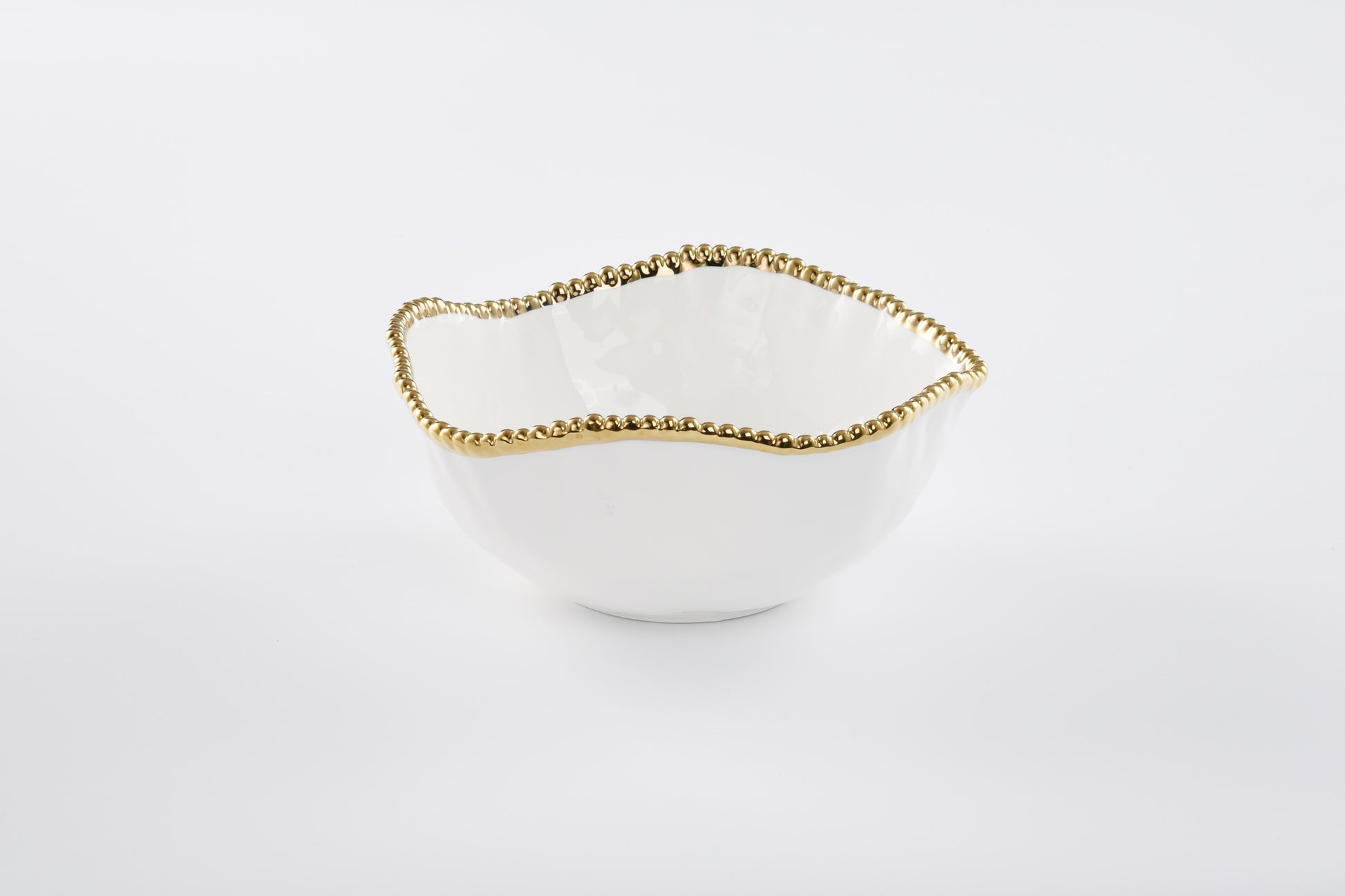 White bowl with gold rim on a white background