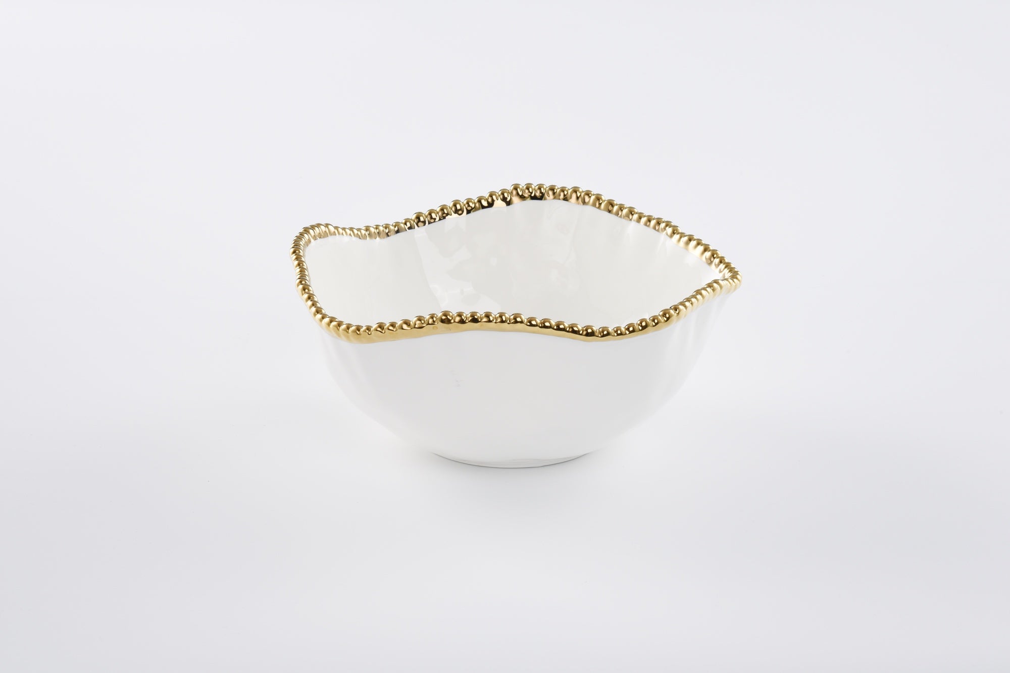 White bowl with gold rim on a white background