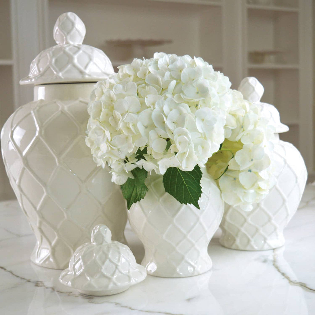 8 Oak Lane Brand White ceramic Ginger jars with white flowers on a marble surface