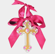 Decorative cross with pink ribbon on a white background