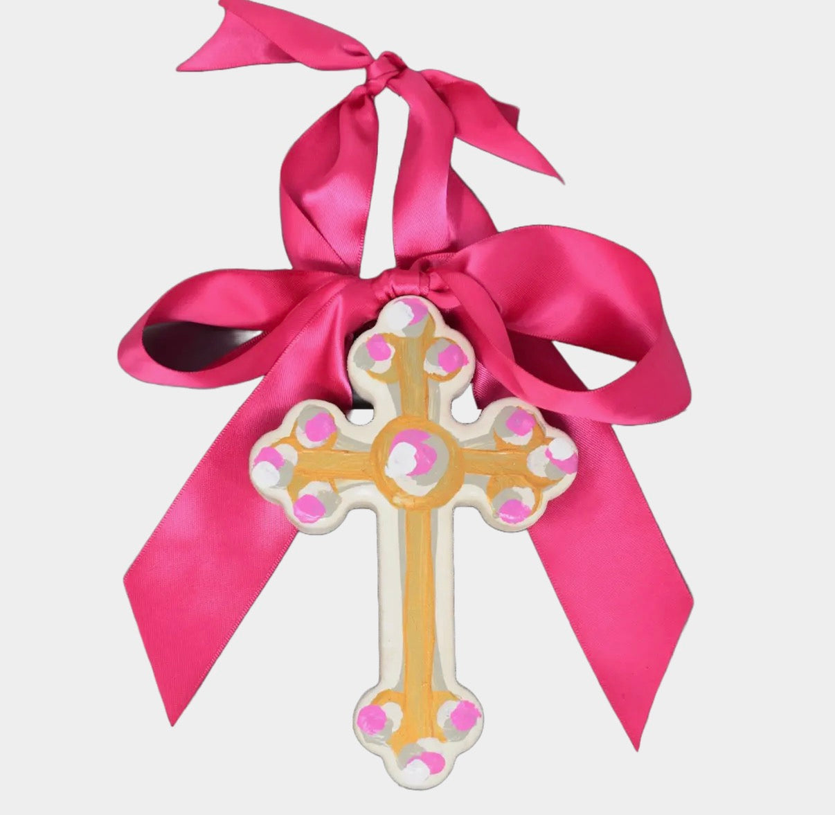 Decorative cross with pink ribbon on a white background