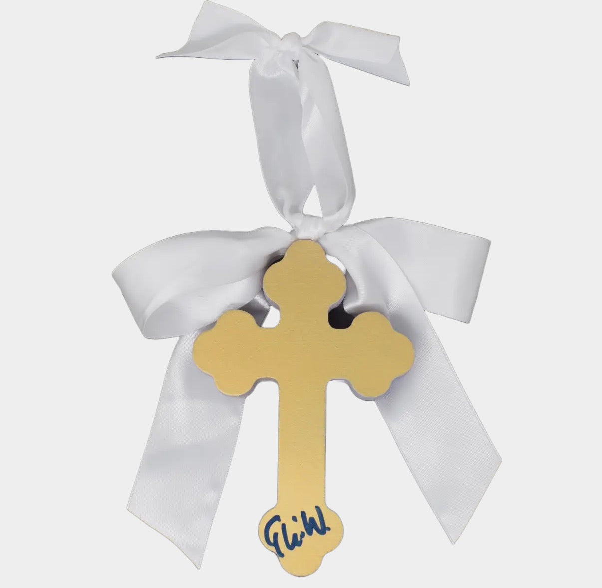 Gold cross with white ribbon on a light gray background