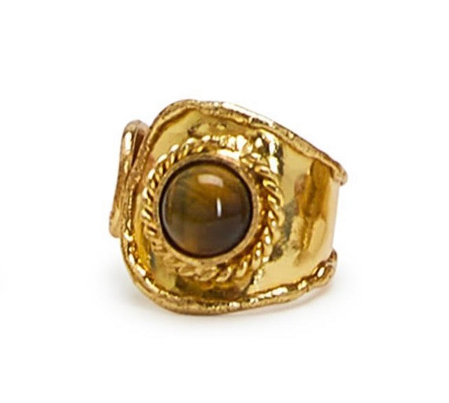 Gold ring with a brown gemstone on a white background