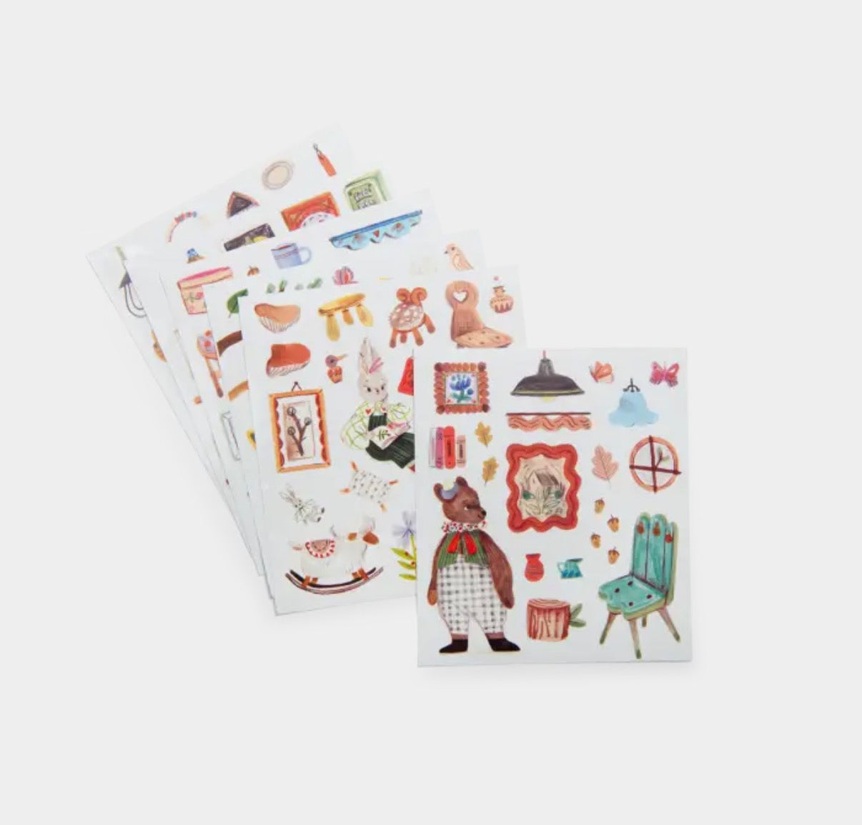 Three sheets of decorative stickers with various illustrations on a white background