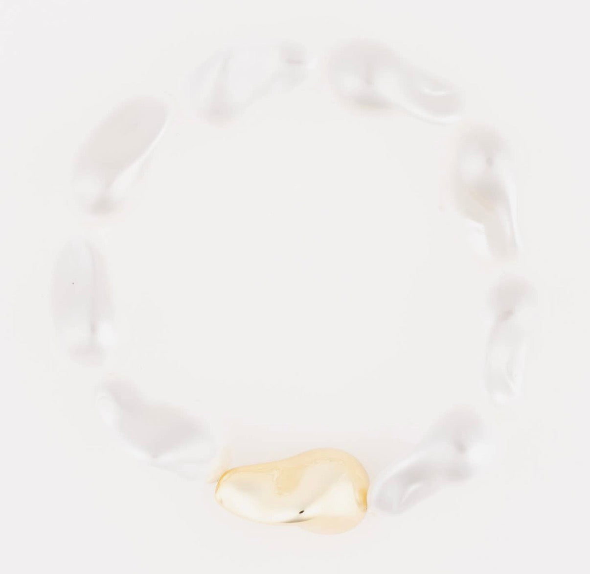 Gold white beaded bracelet on a white background