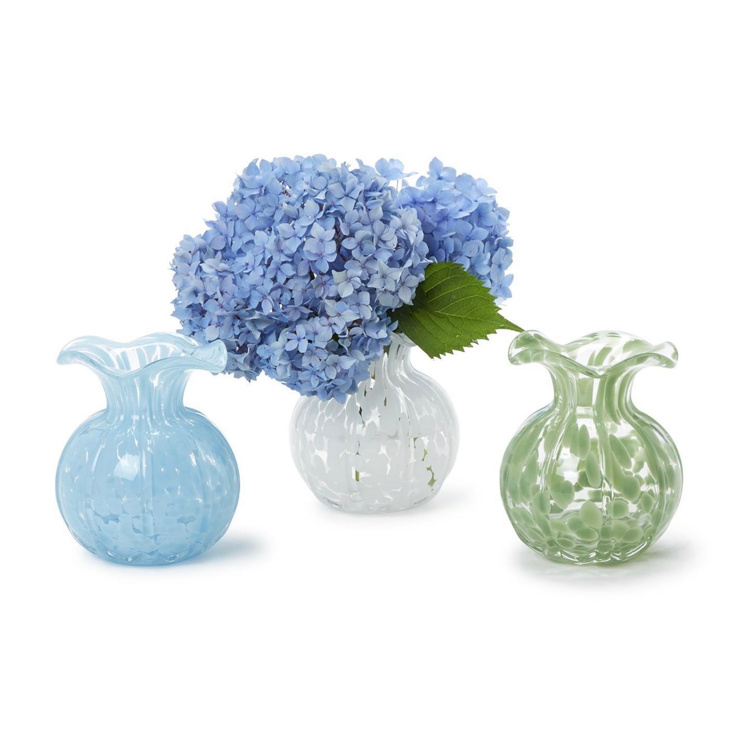 Three glass vases with blue hydrangeas on a white background