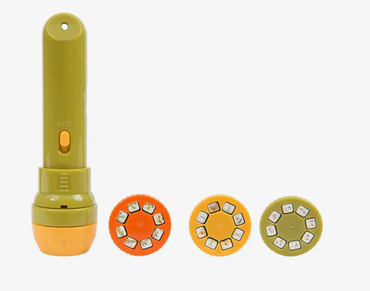 Green and orange toy with interchangeable heads on a white background