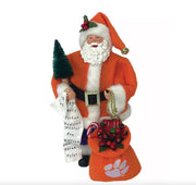 Santa Claus figure with a bag featuring a logo, holding a list and candy canes on a white background