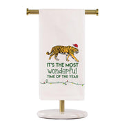 Towel with a tiger design and text on a stand