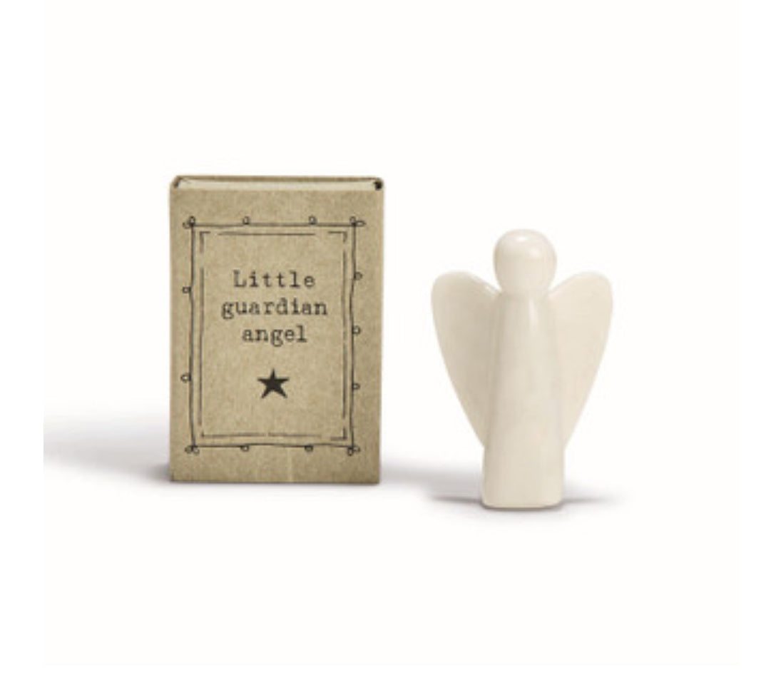 Small angel figurine next to a box labeled 'Little guardian angel' on a white background