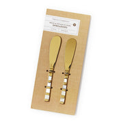 Two gold spreaders on a cardboard backing with 'Two's Company' label.