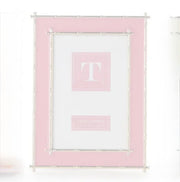Pink 4"x6" picture frame with a white center with Gold Bamboo edges on a white background 